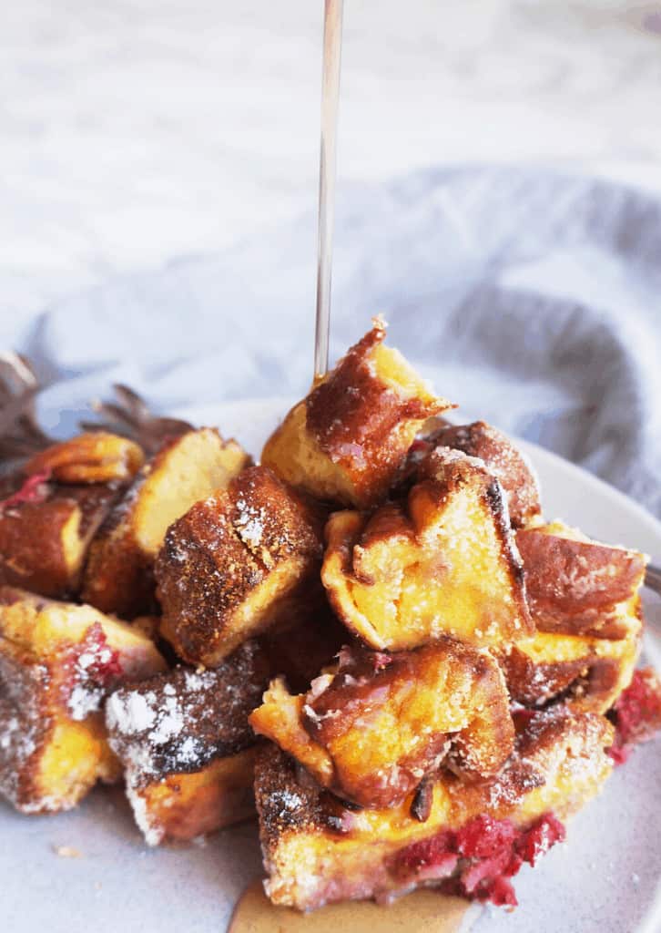 french toast casserole with syrup poured on it