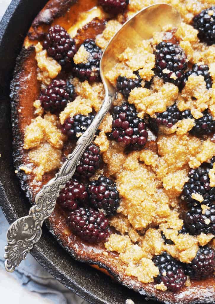 Spoon in Keto Dutch Baby with Blackberry Crumble