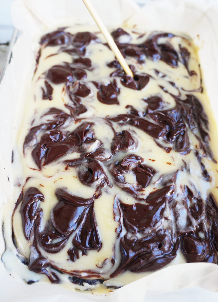 mixing chocolate into white chocolate topping