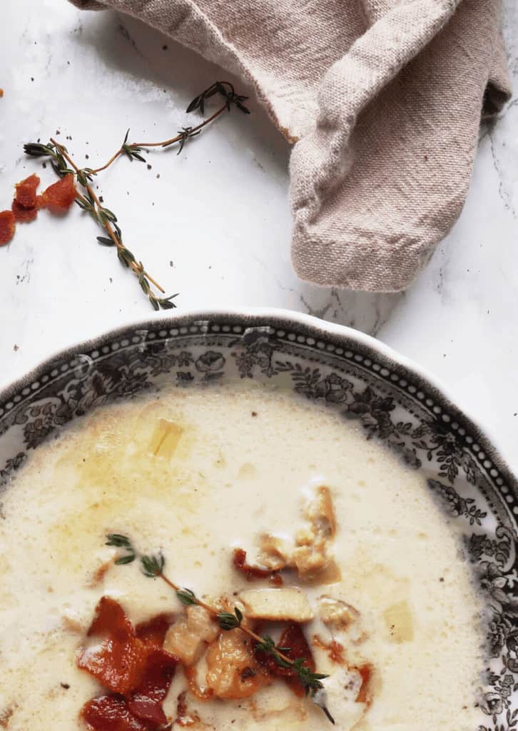 Keto Clam Chowder in a bowl with bacon on top