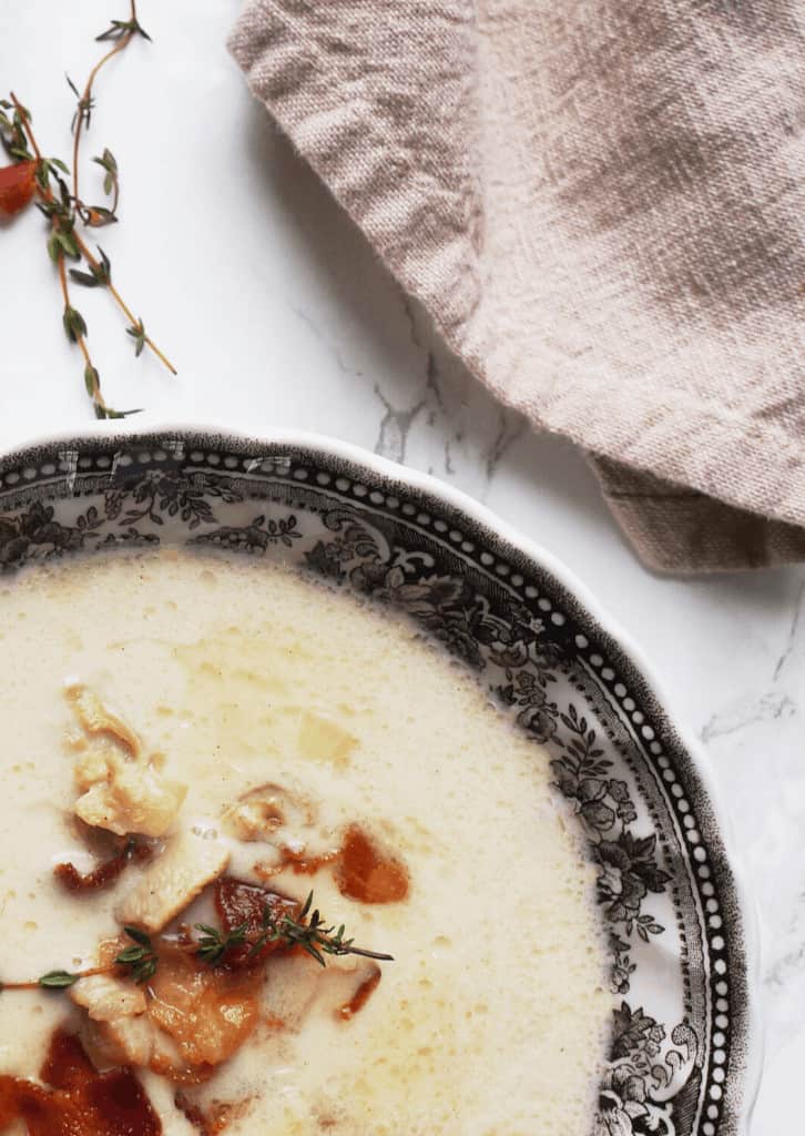 Keto Clam Chowder in a bowl with bacon on top