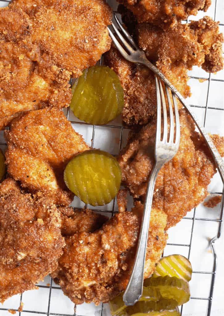 Keto Fried Chicken on a wire rack with pickles