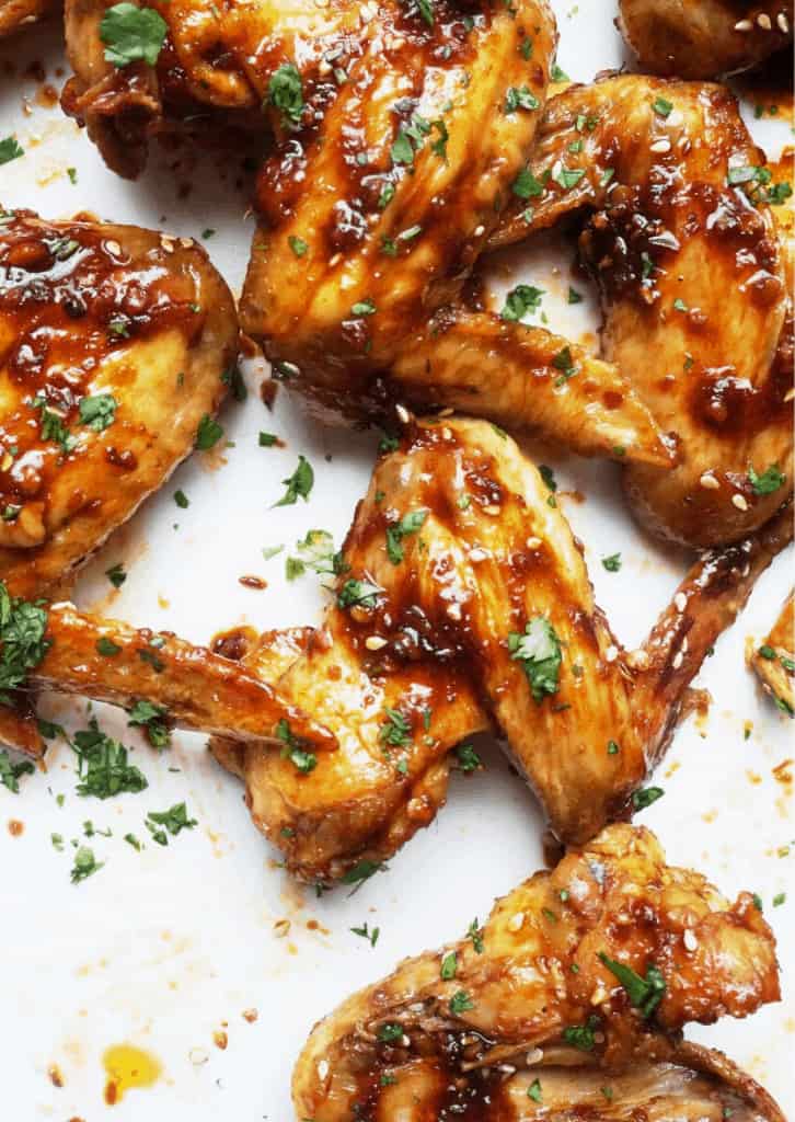 Baked chicken wings covered in a sticky sauce.