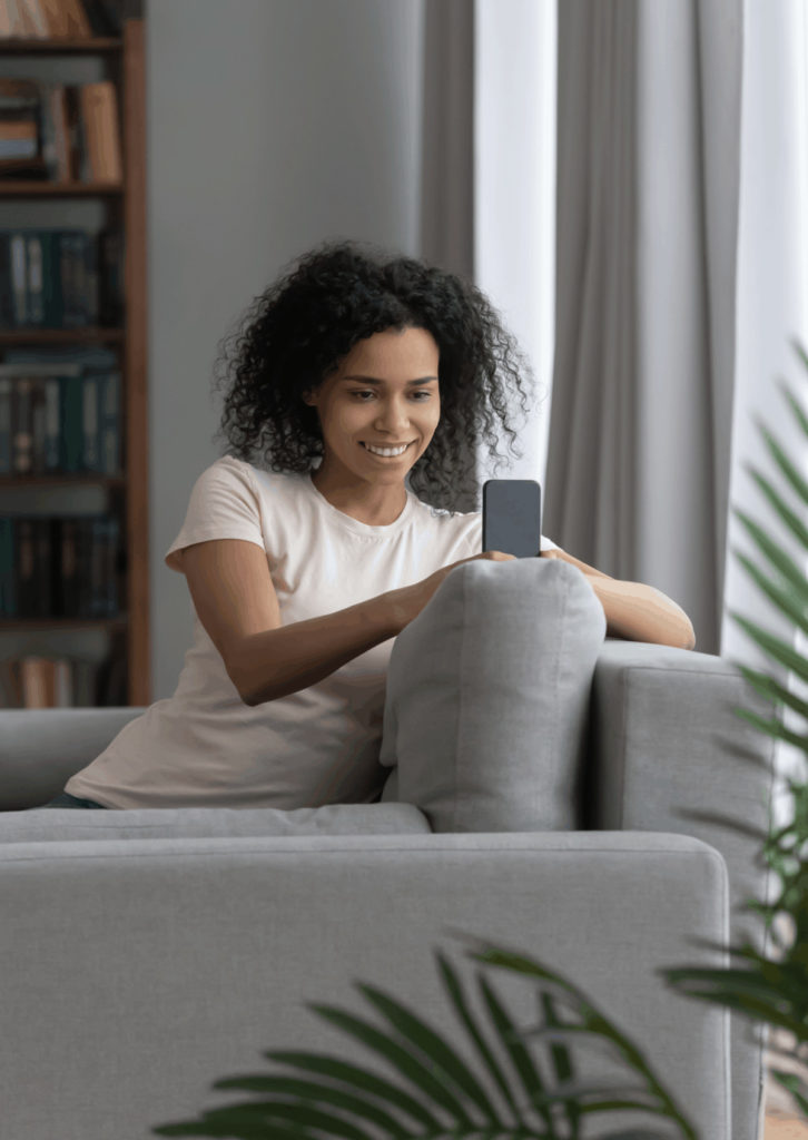 woman on the couch looking at her phone