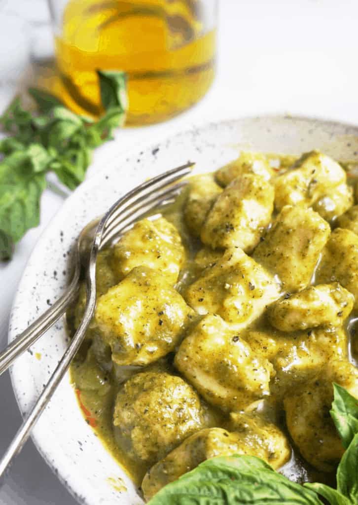 gnocchi in a white bowl with forks on the side 