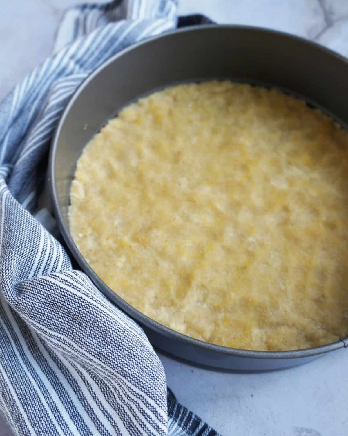 unbaked cheesecake crust in a springform pan