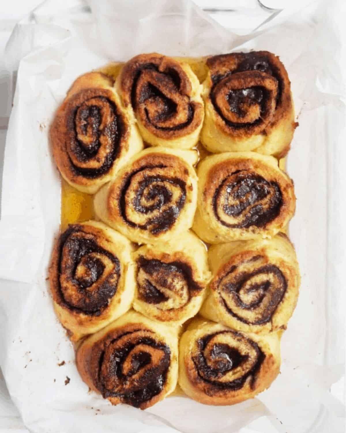 The baked cinnamon rolls in a baking dish right out of the oven