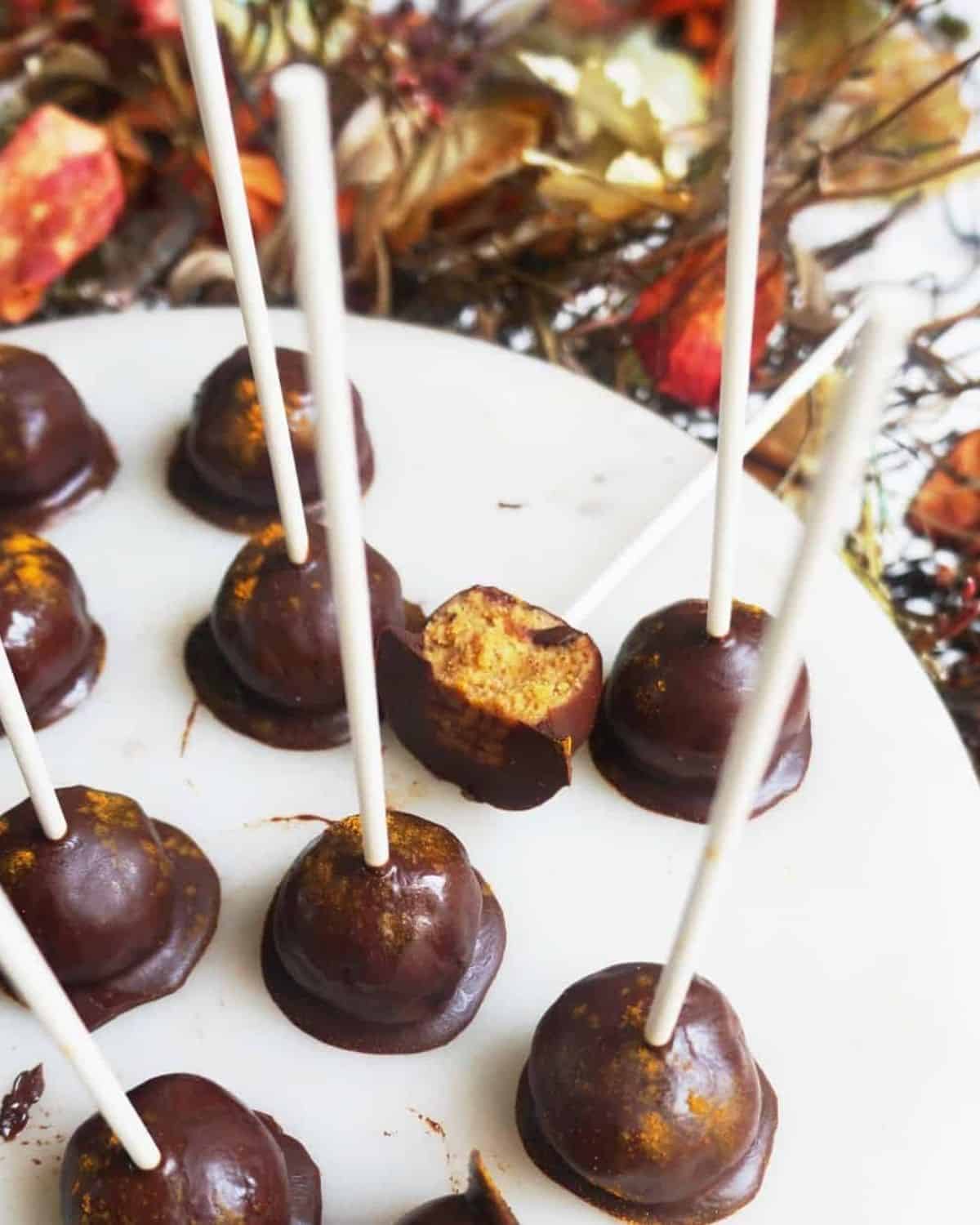 close up shot of Clean Keto Pumpkin Cake Pops on a white plate
